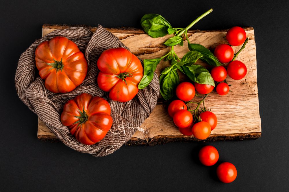 Tomatoes and napkin on wooden board