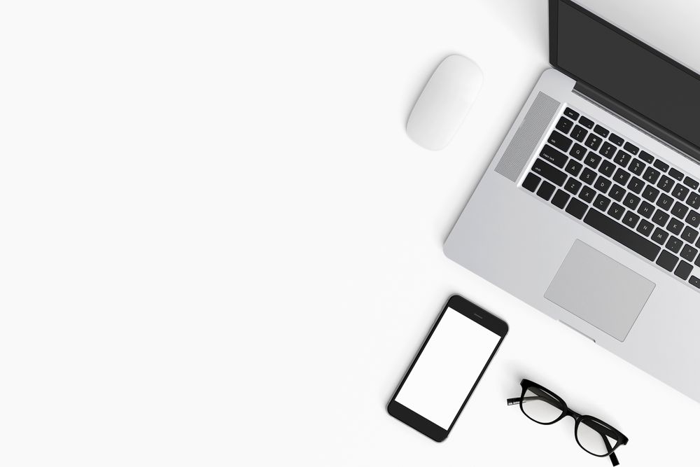 Modern workspace with coffee cup, smartphone and laptop copy space