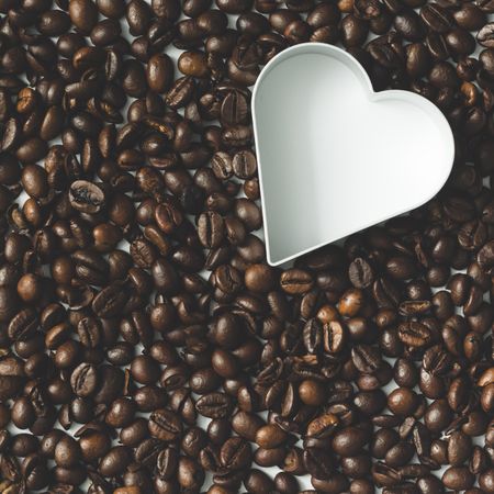 Coffee beans with heart cookie cutter