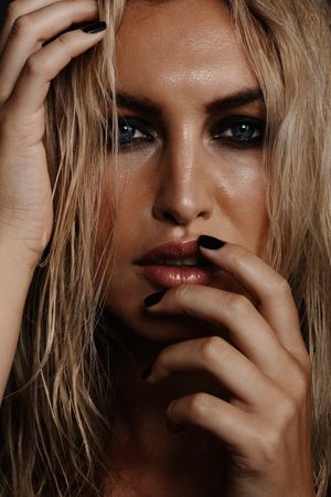 Moody female model with wet makeup