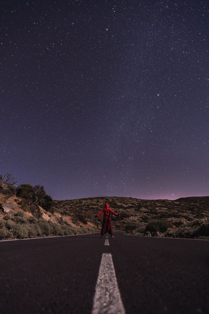Traveler standing on empty road at night