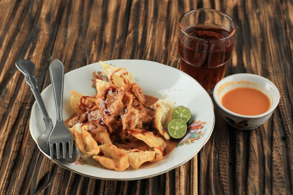 Deep fried fish dumplings with peanut sauce  on dinner table