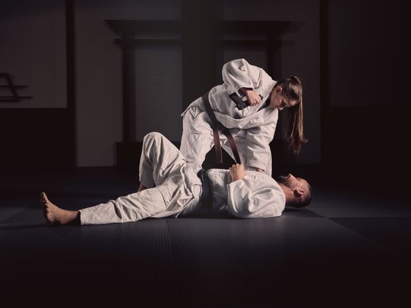Krav Maga trainer teaching man to defend from gun
