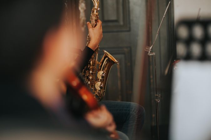 Focus on student holding saxophone instrument