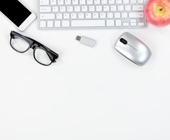 Top border of plain office desktop with modern technology and apple fruit