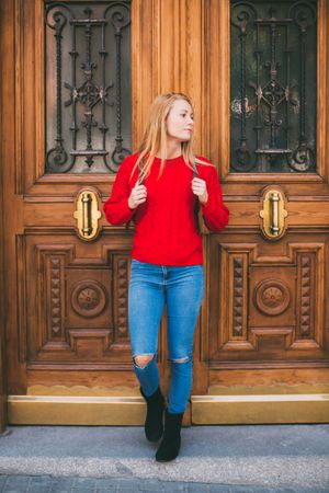 Confident woman near ornamental wall