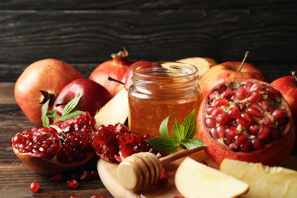 Autumn fruits arranged on a wooden table with dark background