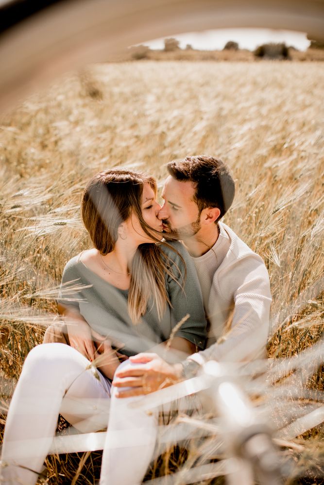 Loving couple resting on rye field