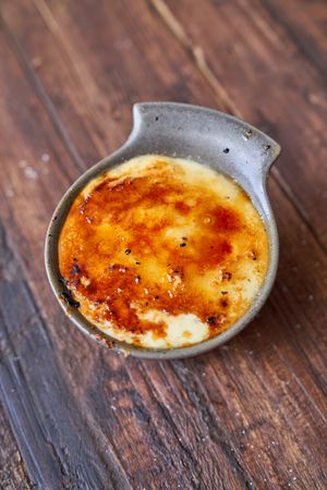 Bowl of tasty dessert on wooden table