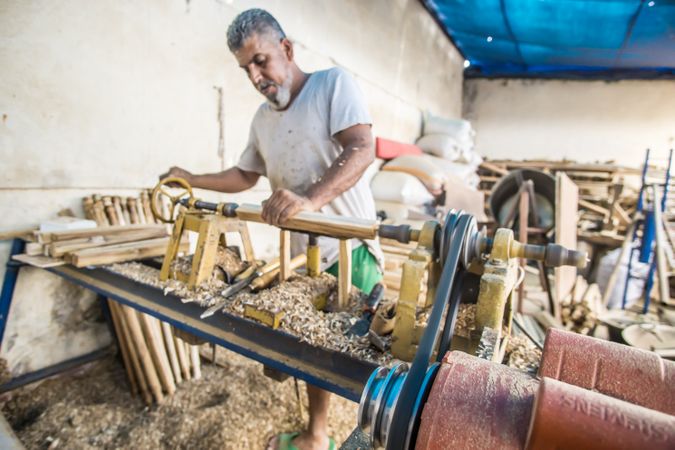 Man using woodworking machine at workplace