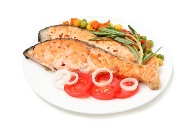 Plate with grilled salmon isolated on blank background