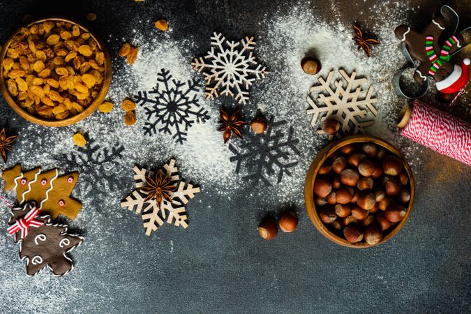 Flour scattered on counter with baking ingredients and snow flakes