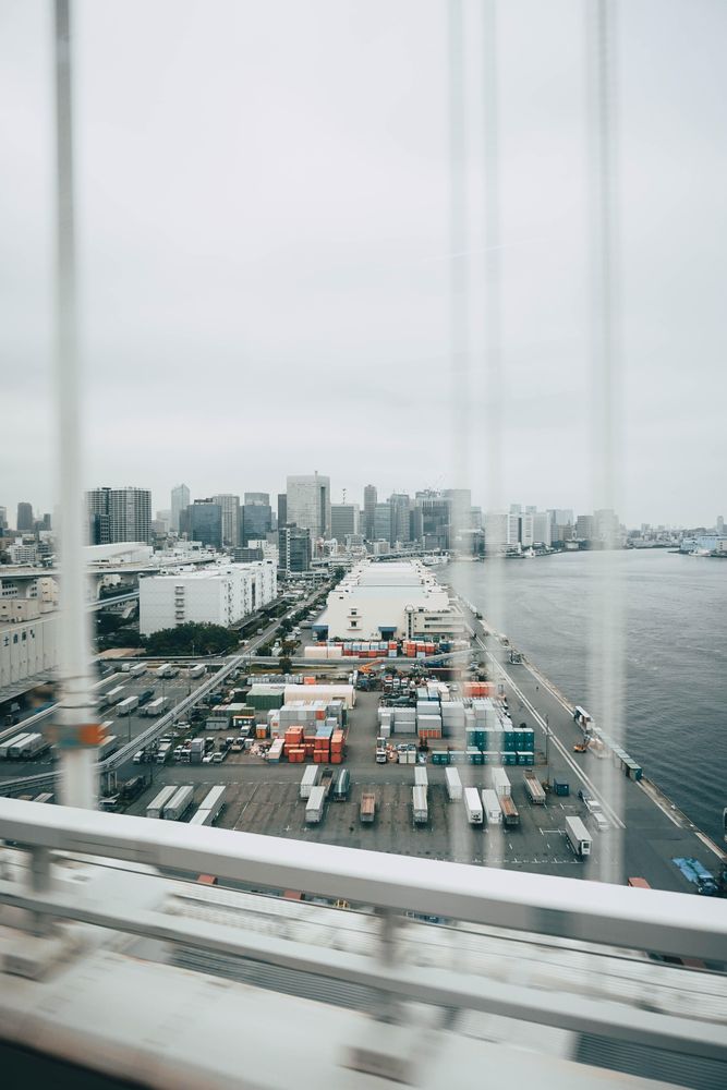 Window view of containers and trucks on dock