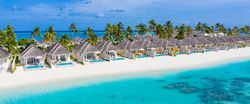 Holiday villas line the beach in the Maldives, wide