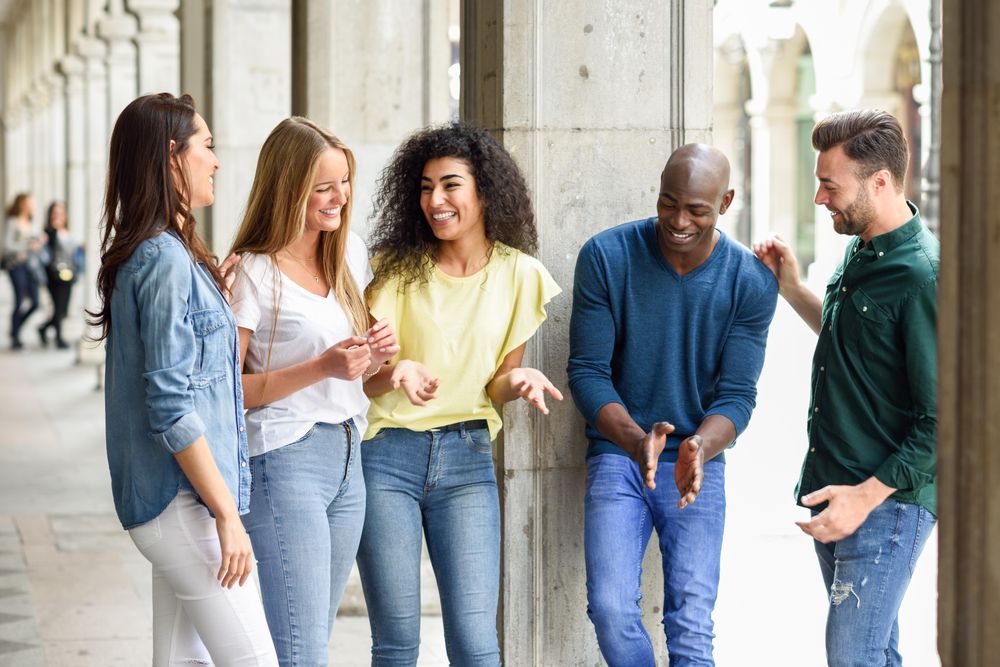 Group of friends standing outside having a conversation