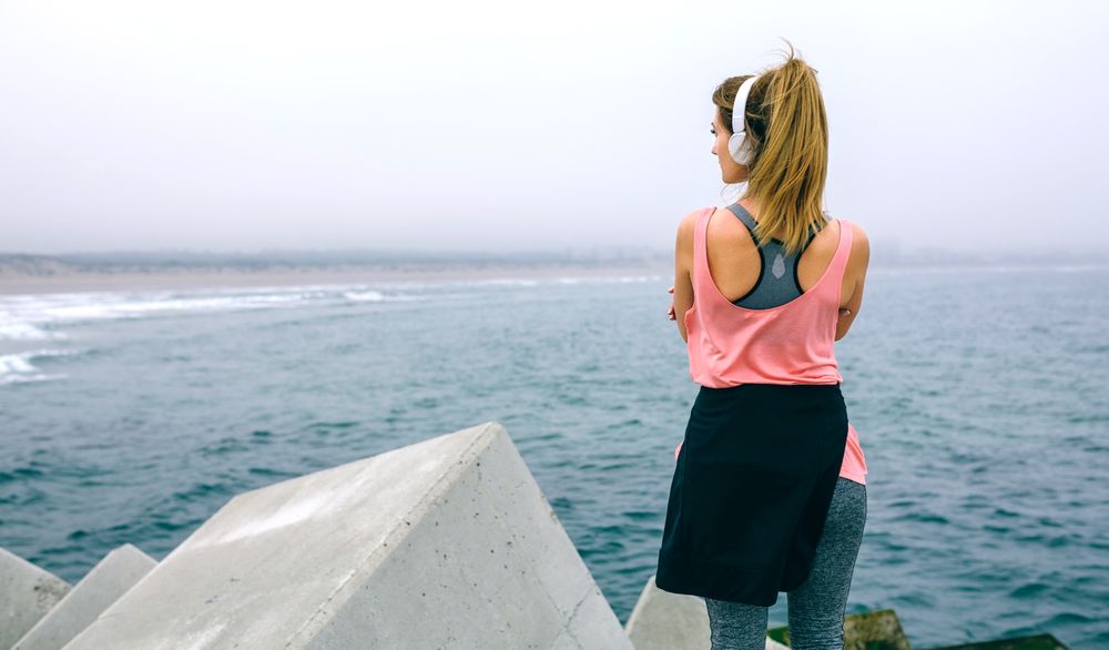 Back of woman standing on pier