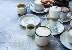 Variety of coffee drinks on table with copy space