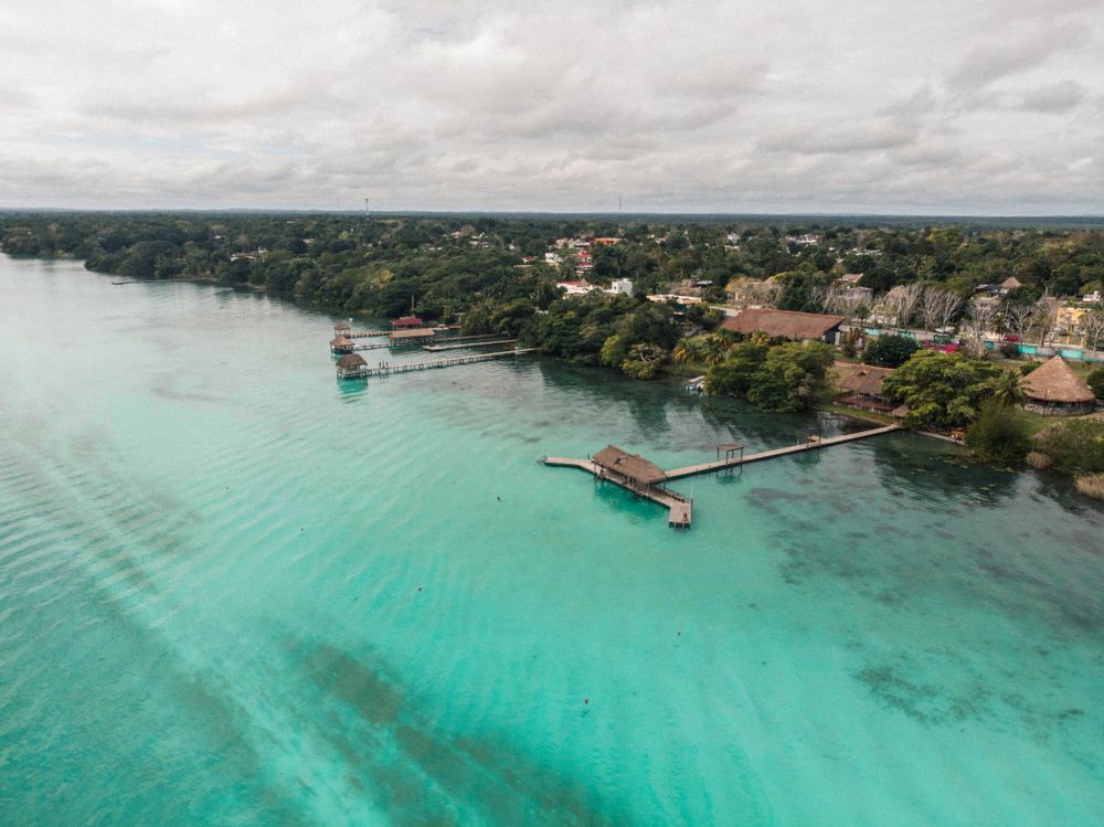 Aerial view of brown bungalows on body of water