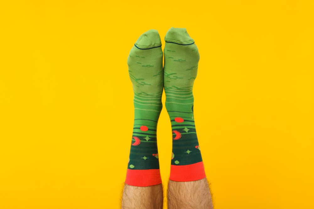 Concept of clothes for legs - socks, socks on male legs