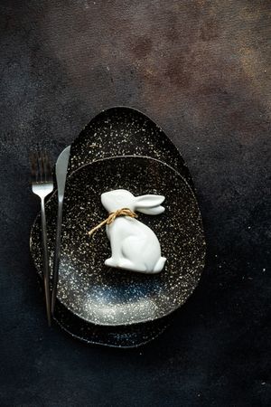 Easter table setting with ornamental rabbit on plate