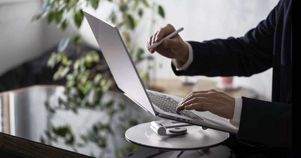Businessman Working on Laptop at Office Desk