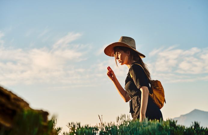 Woman traveler in straw hat walking