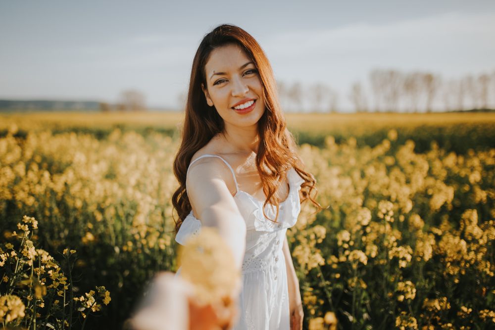 Woman with flowers in field