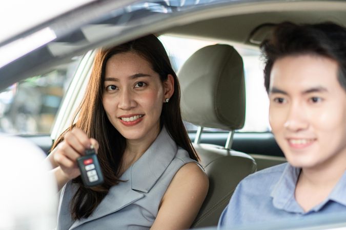 Female with male customer test driving vehicle