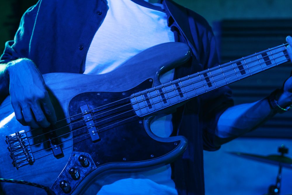 Bass Player Performing In A Live Concert