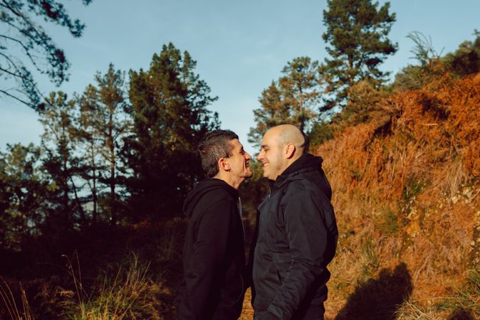 Men kissing in park