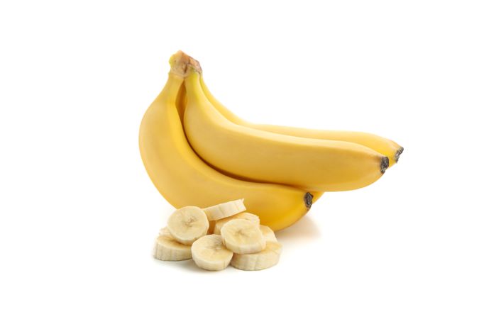 Banana cluster isolated on neutral background. Fresh fruit