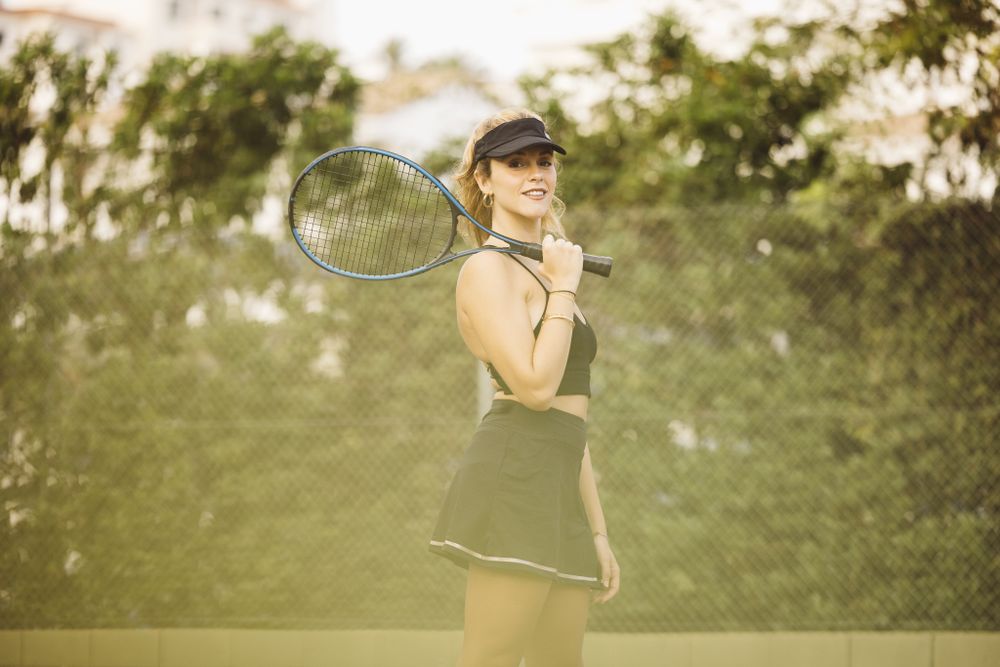 Young woman playing tennis match