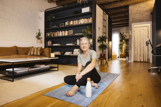 Mature Woman doing yoga at home