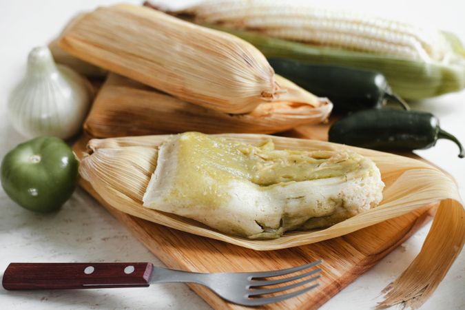 Dough near corn husk and spices for tamales
