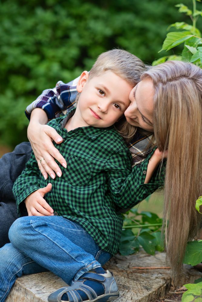 Young mother spending time with son in backyard