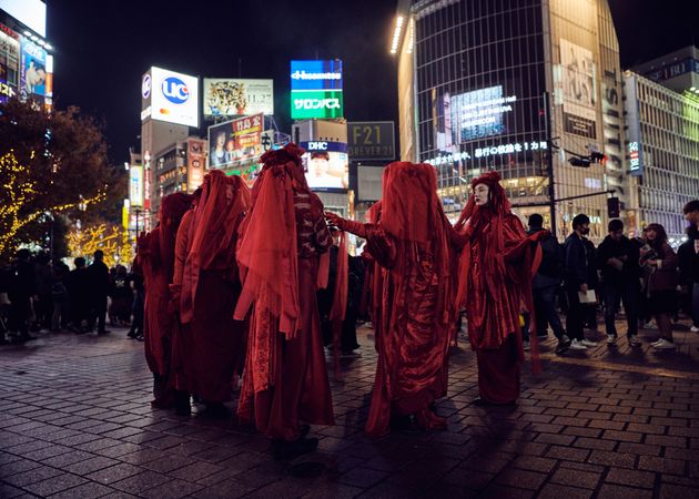 Japan - Tokyo, Shibuya Japan - November 29th, 2019: Red Rebel Brigade stand in a circle in city
