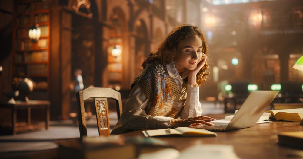 Radiant Young Woman Engaged in Online Education, Using Laptop in Classical Library