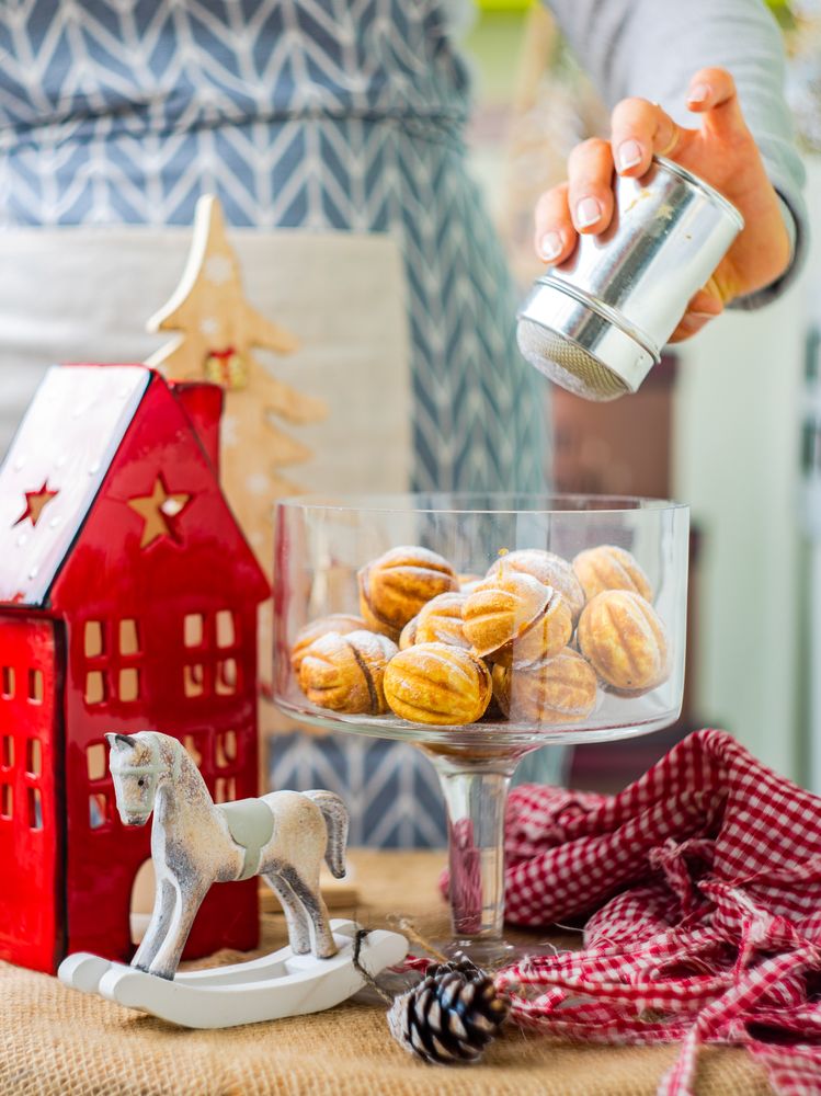 Holiday dessert concept with walnut shaped cookies stuffed with caramel cream