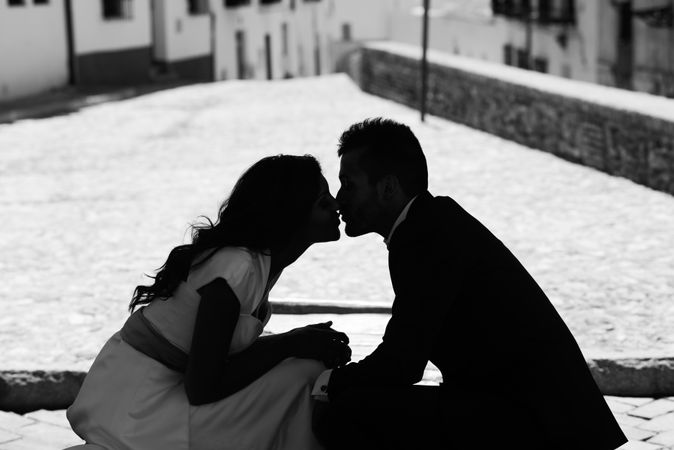 Monochrome silhouette of man and woman kissing