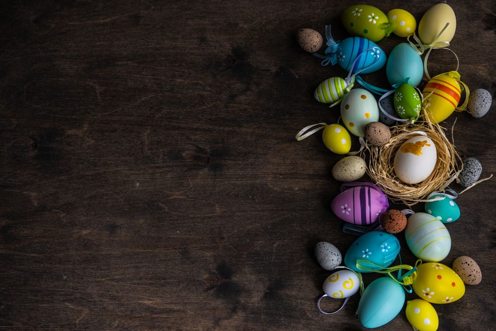 Top view of Easter card concept with colorful eggs on table