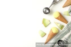 Ice cream cones with pieces of fresh melon on a plain background 5wXa8W