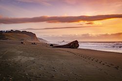 Footprints in the sand on a quiet beach at sunset
