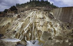 Stream flowing on sandy rock on sunny day