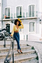 Trendy young female laughing on stairs