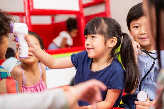 Cute girl playing doctor at school