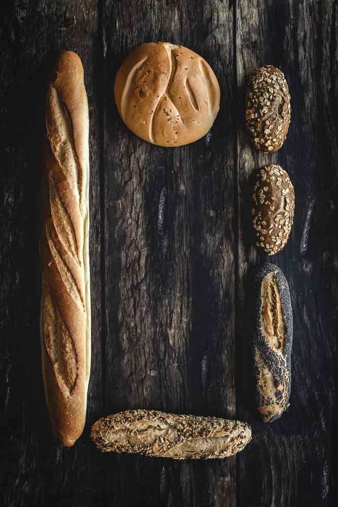 Assorted gold homemade bread on dark wood background