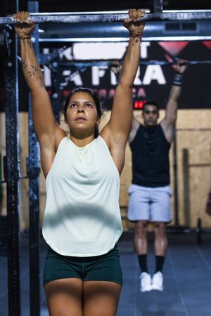 Sportive couple hanging on crossbars