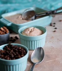 Coffee ice cream with spoon and beans