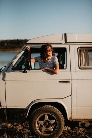 Smiling woman sitting in retro car