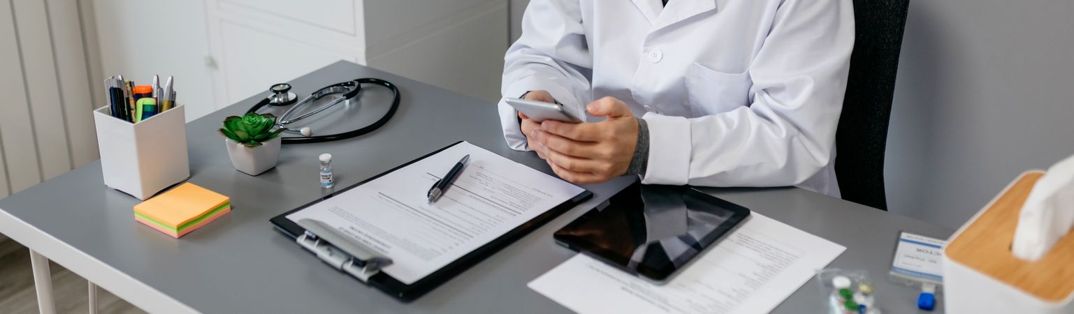Female doctor using mobile while working